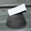 Black leather pocket with white card.