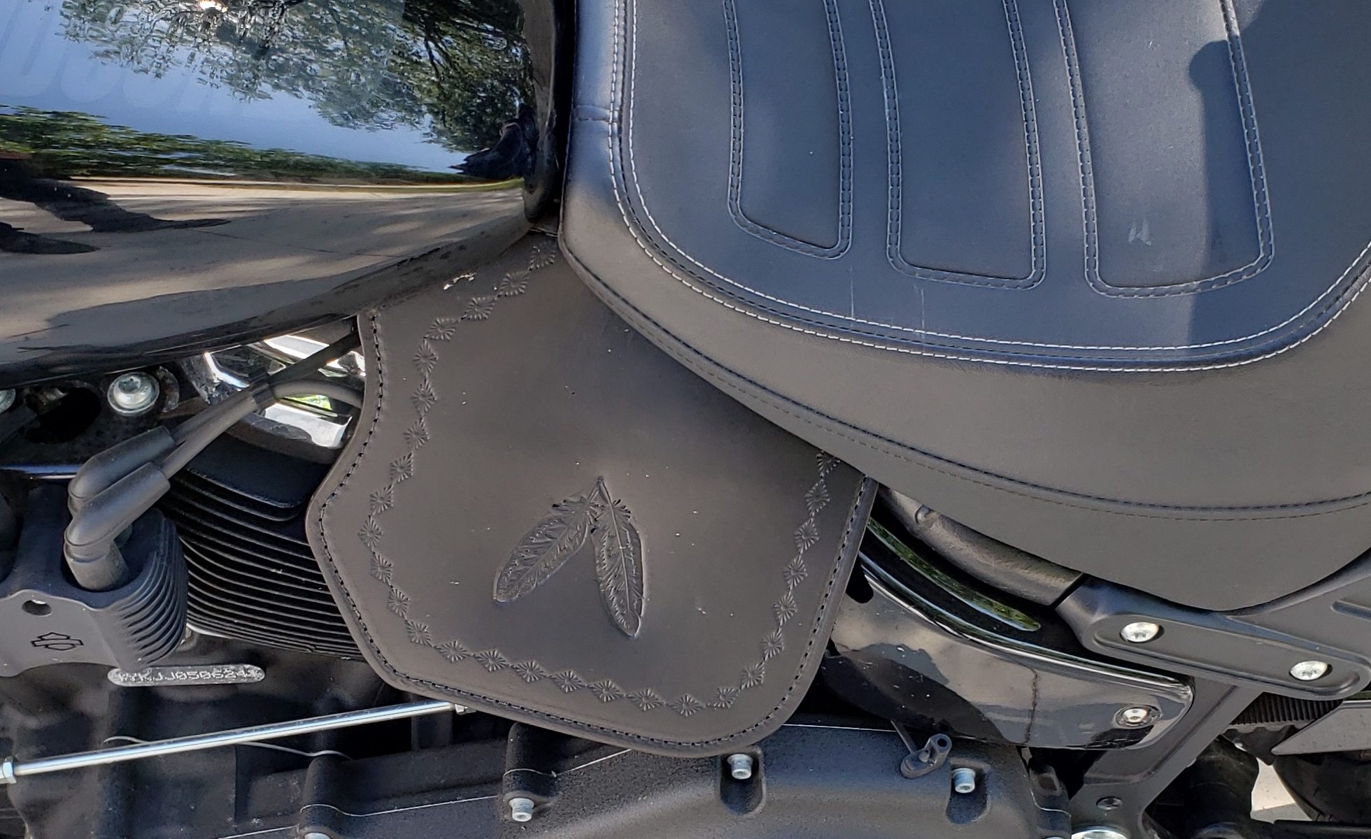 A motorcycle seat is shown with the back of it.