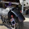 A motorcycle parked next to an airplane.