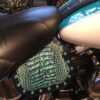 A motorcycle seat with blue leather and turquoise beads.