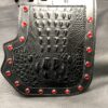 A black leather wallet with red rivets on it.