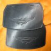 A pair of black leather harley davidson bags.