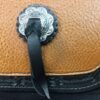 A close up of the leather strap on a purse
