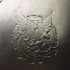A close up of the dragon on the back of a bag