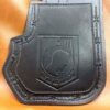 A black leather wallet with a picture of a man 's face on it.