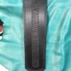 A black leather strap with a design on it.
