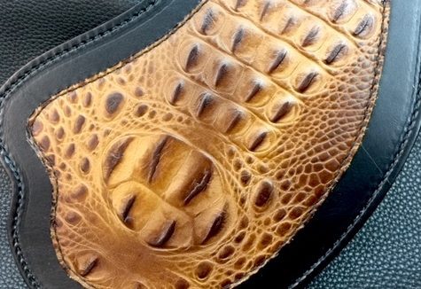 A close up of the alligator skin on a purse