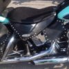A motorcycle seat with blue and black trim.
