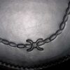 A chain is attached to the bottom of a hat.