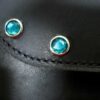 A close up of the blue stones on the leather.