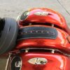 A close up of the back end of a red motorcycle.