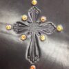 A cross with orange stones on it