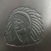 A close up of the indian head on a leather bag