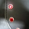 A close up of the buttons on a leather jacket.