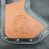A leather bag with an indian head on it.