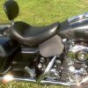 A motorcycle seat is shown with the back rest up.