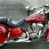 A red motorcycle parked on the side of a road.