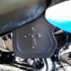 A close up of the cross on the back of a motorcycle.