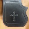 A close up of the cross on the cover