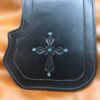 A black leather wallet with a cross on it.