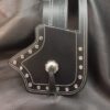 A black leather wallet with silver rivets on it.