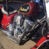 A close up of the engine on a red motorcycle.