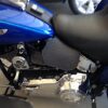 A close up of the seat and engine on a motorcycle.