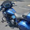 A blue motorcycle parked in the parking lot.