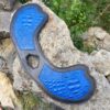 A blue and black object is on the ground