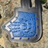 A blue and black leather wallet on the rocks.