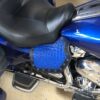 A blue motorcycle seat with black trim and rivets.