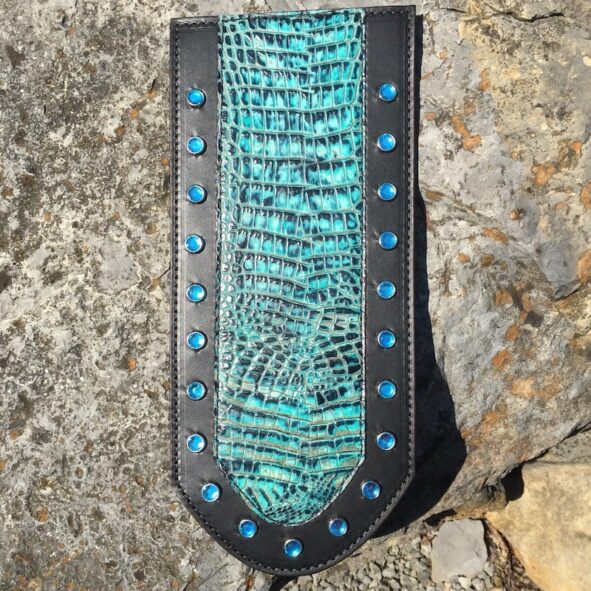 A black and blue leather wallet with turquoise stones.