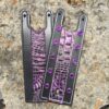 A pair of purple and black leather bracelets.
