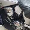 A motorcycle with chrome and black leather seats.