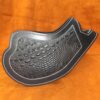 A black leather object with a pattern on it.