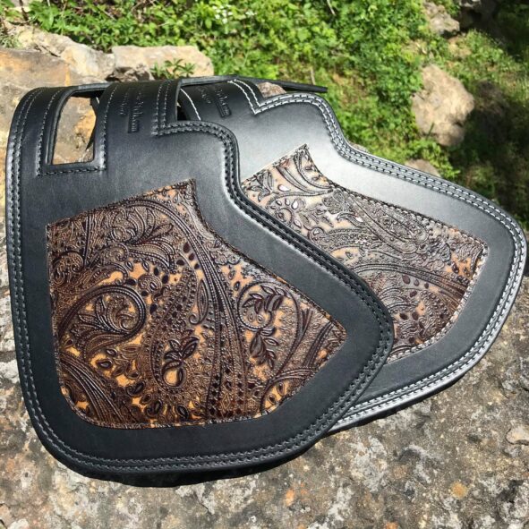 A black leather bag with brown paisley design.