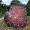 A red and black leather holster with red studs.