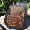 A leather wallet with a brown design on it.
