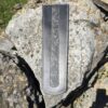 A knife is sitting on the rock
