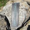 A knife that is sitting on some rocks
