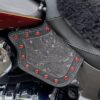 A close up of the red rivets on a motorcycle