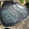 A pair of black and blue leather motorcycle saddlebags.