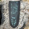 A close up of the top of a knife sheath