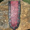 A leather bookmark with red rivets on it.