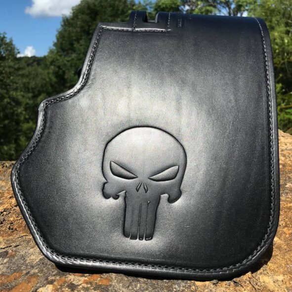 A black leather bag with a skull on it