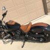 A motorcycle parked in front of a garage door.