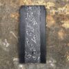 A black and white wallet sitting on the ground.