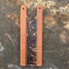 A brown leather strap with a snake print on it.