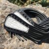 A pair of black and white leather straps on the ground.
