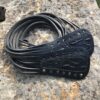 A pair of black leather straps on the ground.